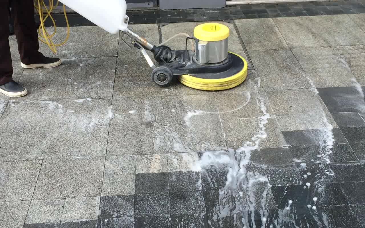team of professionals polishing granite floor